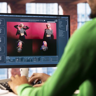 Ein Benutzer arbeitet an einem Computer, während er Bilder einer Person mit pinken Haaren und gestreiftem Oberteil betrachtet.